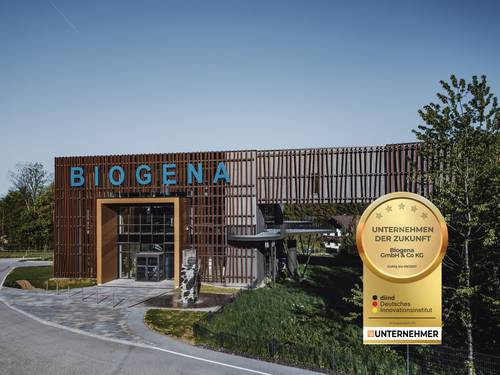 A modern building with a sign reading ‘BIOGENA’ and an award bearing the words ‘Company of the Future’, set against a bright blue sky.
