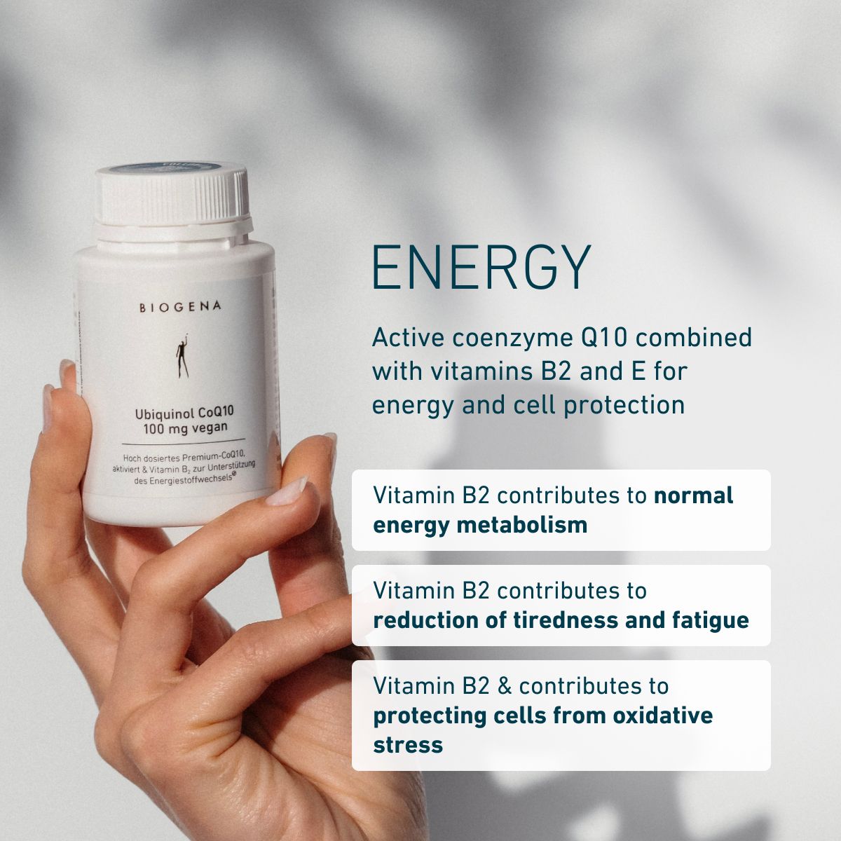 Hand holding BIOGENA Ubiquinol CoQ10 100 mg vegan bottle. Graphic highlights active coenzyme Q10 with vitamins B2 and E, supporting normal energy metabolism, reducing tiredness and fatigue, and protecting cells from oxid