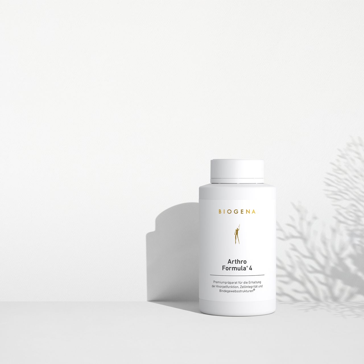 BIOGENA Arthro Formula 4 in a white bottle placed on a surface, with plant shadows in the background. The label reads "Premium preparation for maintaining joint functions."