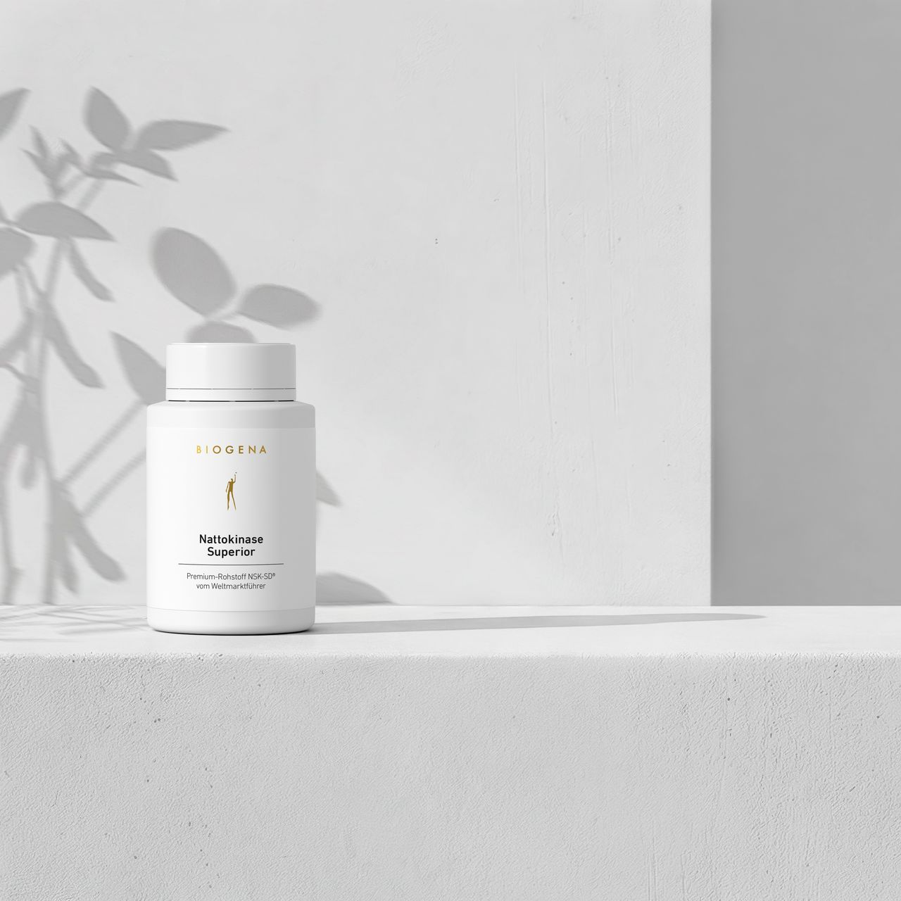 BIOGENA Nattokinase Superior supplement bottle on a minimalist white background with soft plant shadows. Premium formula with nattokinase.