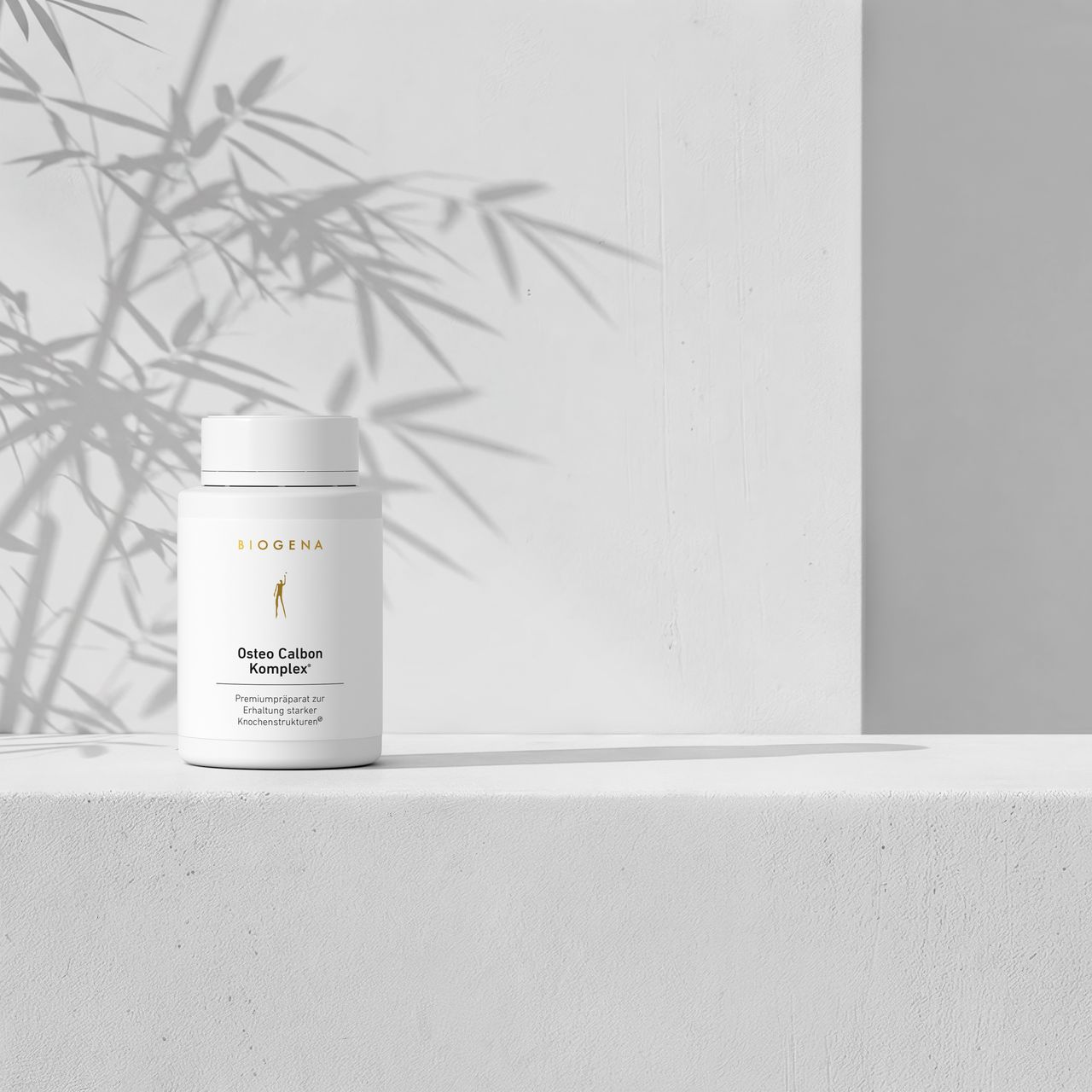 Osteo Calbon Complex® bottle on a minimalist white background with soft shadows creating a calming atmosphere.