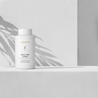 BIOGENA Arthro UMP Lumbal in a white bottle placed on a surface, with plant shadows in the background. The label reads "For the maintenance of nerve cells and in the area of the back."