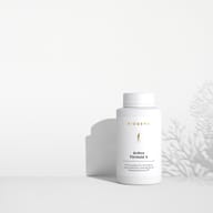 BIOGENA Arthro Formula 4 in a white bottle placed on a surface, with plant shadows in the background. The label reads "Premium preparation for maintaining joint functions."