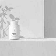 BIOGENA Nattokinase Superior supplement bottle on a minimalist white background with soft plant shadows. Premium formula with nattokinase.