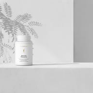 BIOGENA Quercetin Phytoactive supplement in a white bottle on a minimalist background with light and plant shadows. Contains quercetin with phytosome technology for improved bioavailability.