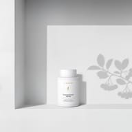 BIOGENA ThromboPhenol 150/50 in a white bottle placed on a shelf, with plant shadows in the background. The label reads "For maintaining blood flow."