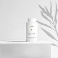 BIOGENA Ubiquinol CoQ10 100 mg vegan in a white bottle placed on a surface, with plant shadows in the background. The label reads "High-dose premium CoQ10, supports vitamin B6 for energy metabolism."