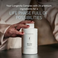 Photo of a hand holding Biogena Best Age Superior bottle, text highlights 24 premium ingredients supporting skin, energy metabolism, nerves, mental health, and normal blood sugar levels.