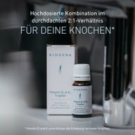 Packung und Fläschchen der BIOGENA Vitamin D₃ & K₂ Tropfen stehen auf einer Arbeitsfläche. Der Text beschreibt die hochdosierte 2:1-Kombination aus Vitamin D und K zur Unterstützung der Erhaltung normaler Knochen.